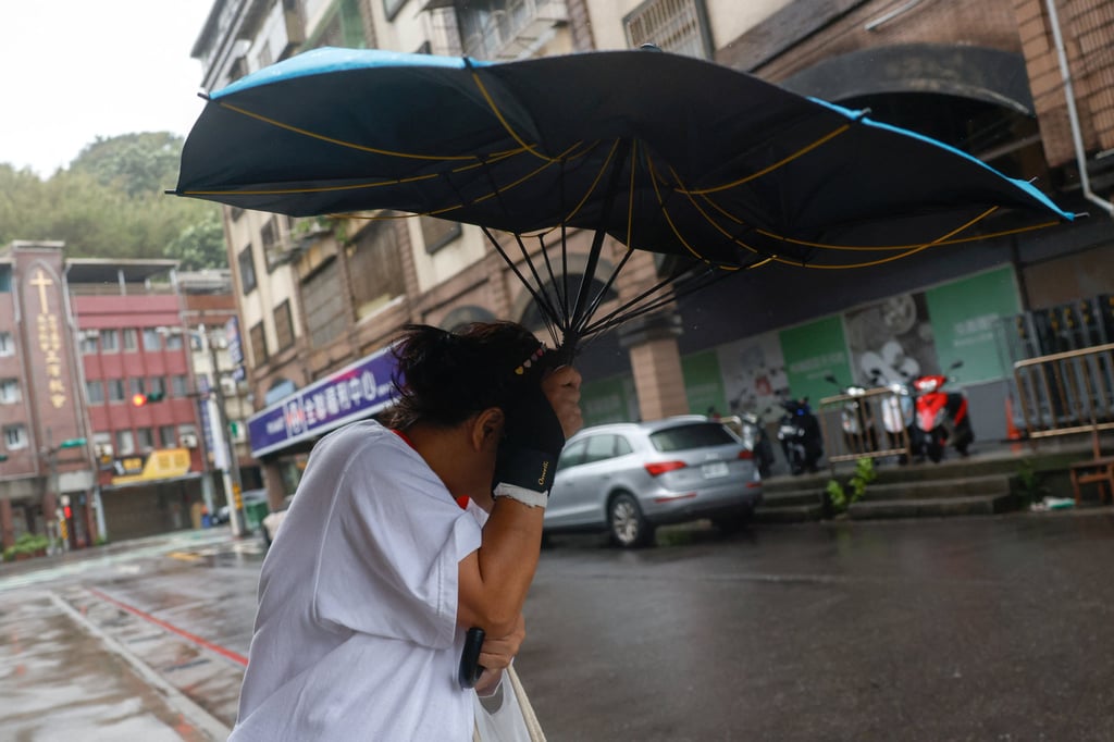 A pedestrian in Keelung, Taiwan, holds an umbrella as Typhoon Champi approaches on Friday. Photo: Reuters