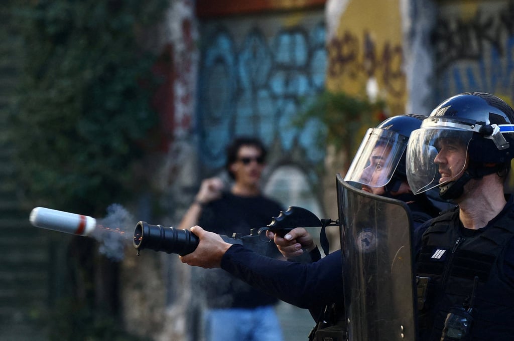 French police fire a tear gas canister. Photo: Reuters