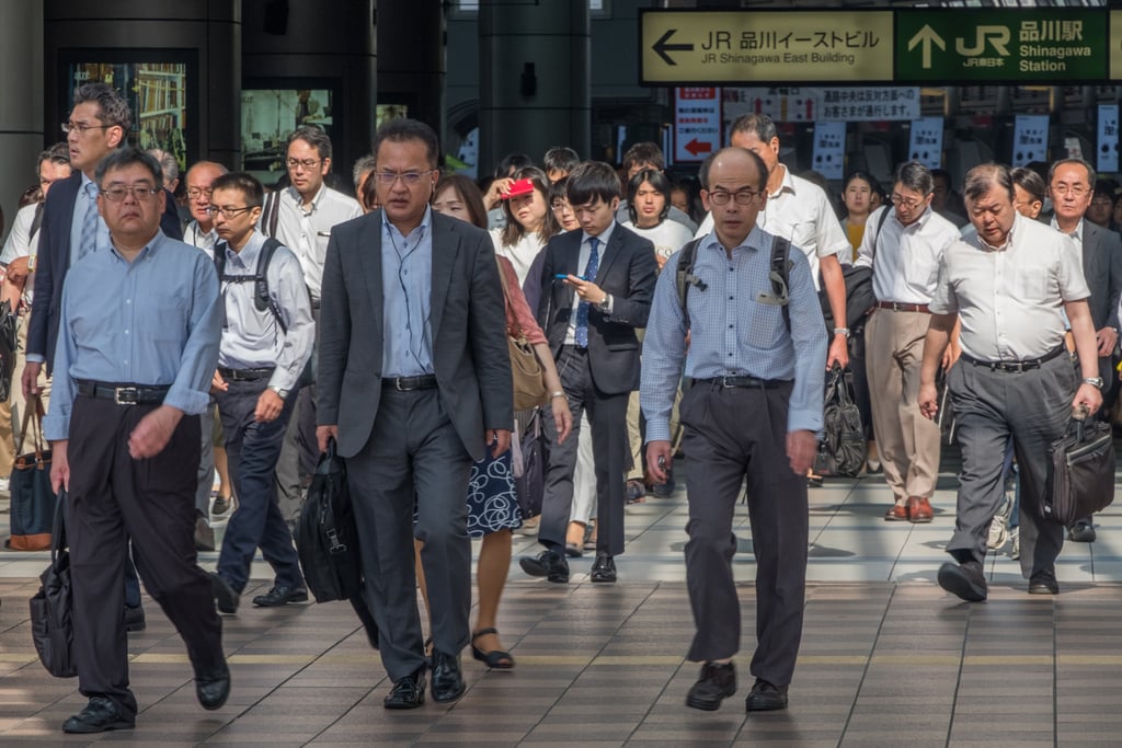 Japanese white-collar workers, or salarymen, in Tokyo. Male corporate employees can be relocated far from their families for years at a time. Photo: Shutterstock