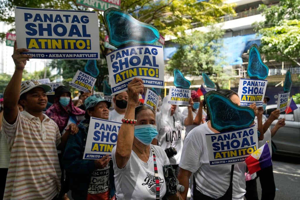 Protesters hold placards during a rally outside the Chinese consulate in Makati, Philippines, last year. Photo: AP