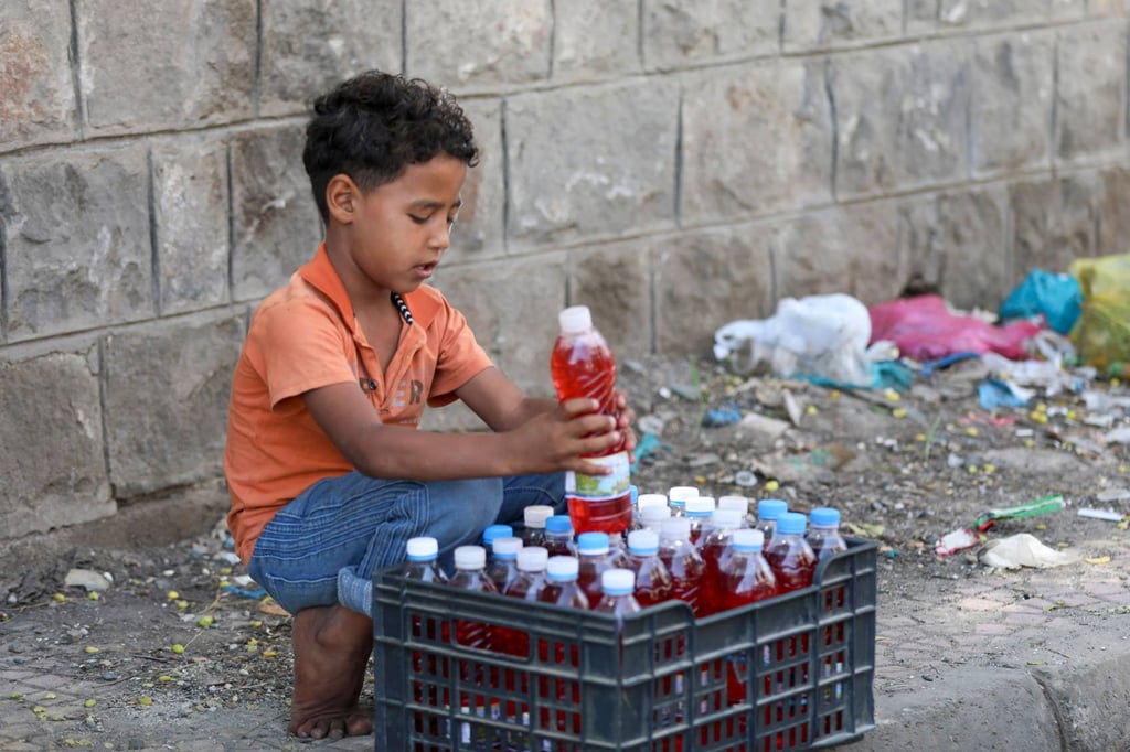 A Yemeni child arranges bottles of fuel into a crate which will be sold along the roadside in the city of Taiz, on October 10. Photo: AFP A Yemeni child arranges bottles of fuel into a crate which will be sold along the roadside in the city of Taiz, on October 10. Photo: AFP