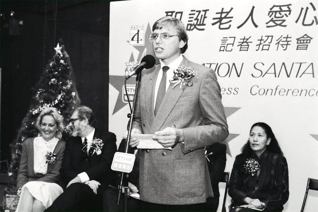 Tony Baynes (standing), head of RTHK’s Radio 3, speaks at a press conference about Operation Santa Claus in 1989. Sitting at right is Miami Chow, chairwoman and founder of the Children’s Cancer Fund. Photo: SCMP Tony Baynes (standing), head of RTHK’s Radio 3, speaks at a press conference about Operation Santa Claus in 1989. Sitting at right is Miami Chow, chairwoman and founder of the Children’s Cancer Fund. Photo: SCMP