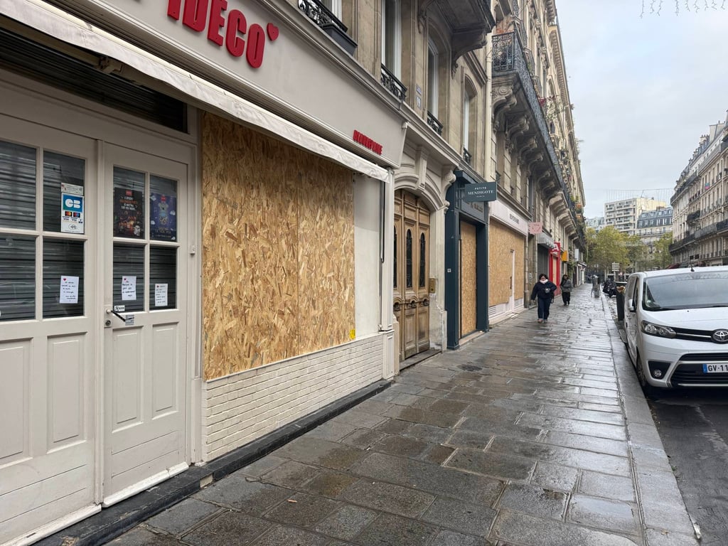 Plywood covers storefronts along Rue Beaurepaire in central Paris on Saturday, as merchants prepared for fresh demonstrations. Photo: Xiaofei Xu Plywood covers storefronts along Rue Beaurepaire in central Paris on Saturday, as merchants prepared for fresh demonstrations. Photo: Xiaofei Xu