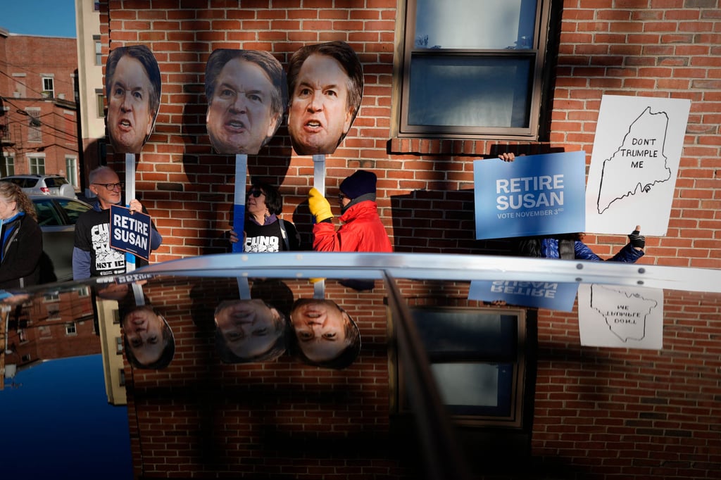 Protesters hold photos of US Supreme Court Justice Brett Kavanaugh near a campaign stop by Senator Susan Collins in Lewiston, Maine, on Wednesday. Photo: AP Protesters hold photos of US Supreme Court Justice Brett Kavanaugh near a campaign stop by Senator Susan Collins in Lewiston, Maine, on Wednesday. Photo: AP