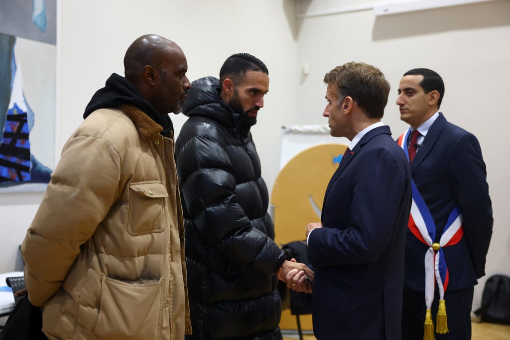 French President Emmanuel Macron meets community members at the town hall in Trappes, near Paris, after a shooting on Friday. Photo: AP French President Emmanuel Macron meets community members at the town hall in Trappes, near Paris, after a shooting on Friday. Photo: AP