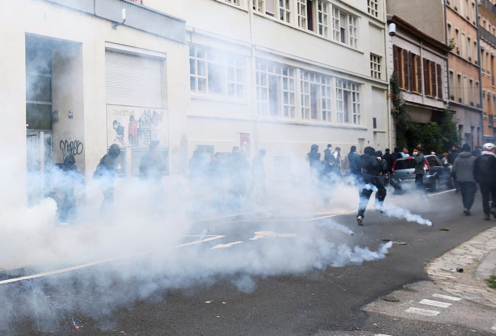 People disperse after tear gas is deployed in Lyon. Photo: Reuters People disperse after tear gas is deployed in Lyon. Photo: Reuters