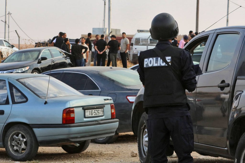 People and security forces gather outside a Greek Orthodox church in Hammoud after a shooting on Friday. Photo: AFP People and security forces gather outside a Greek Orthodox church in Hammoud after a shooting on Friday. Photo: AFP