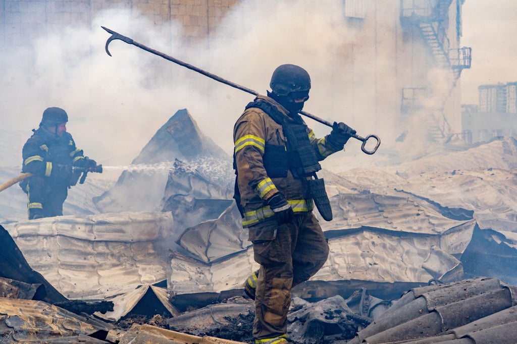 Rescuers work on the roof of a damaged building after a Russian air attack in Kharkiv, Ukraine, on Friday. Photo: AP
