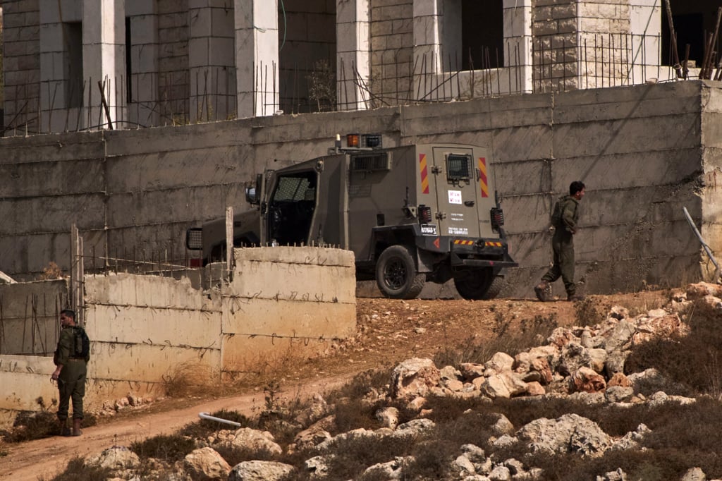 Soldiers stand next to a Palestinian house which was taken over by the Israeli army in the West Bank village of Abu Falah on Saturday. Photo: AP Soldiers stand next to a Palestinian house which was taken over by the Israeli army in the West Bank village of Abu Falah on Saturday. Photo: AP
