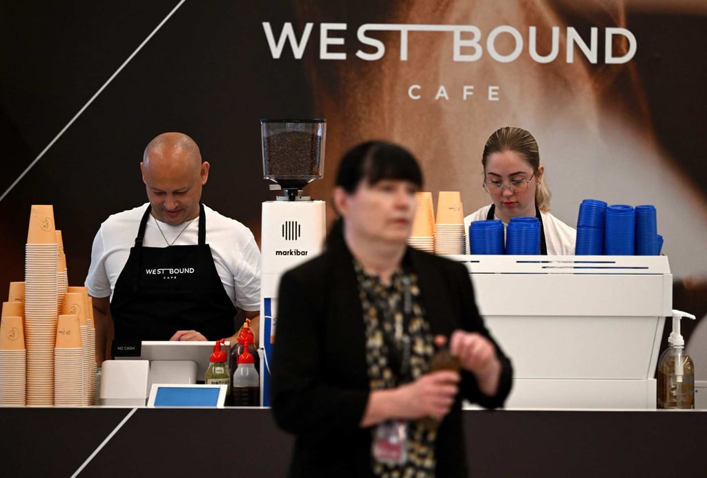 Workers prepare coffee for passengers at the newly opened Western Sydney International Airport on Monday. Photo: AFP Workers prepare coffee for passengers at the newly opened Western Sydney International Airport on Monday. Photo: AFP