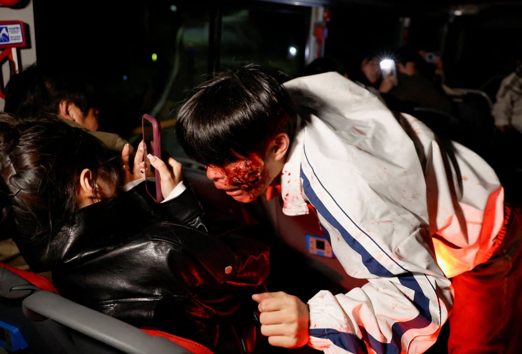 An actor dressed as a zombie leans towards a passenger aboard a bus during the “Seoul City Tour Tiger Bus Zombie Attack” event ahead of Halloween in Seoul, South Korea, on Wednesday last week. Photo: Reuters