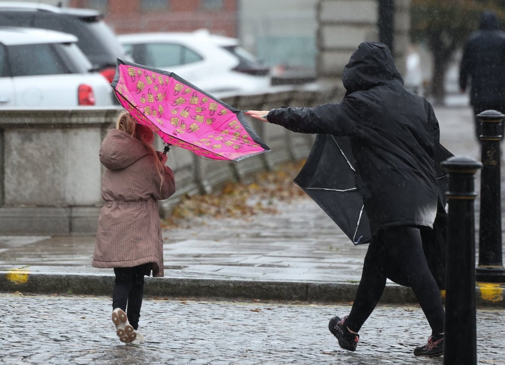 People struggle to hold their umbrellas against strong winds in Liverpool as Storm Boelo affects Britain over the weekend. Photo: EPA People struggle to hold their umbrellas against strong winds in Liverpool as Storm Boelo affects Britain over the weekend. Photo: EPA