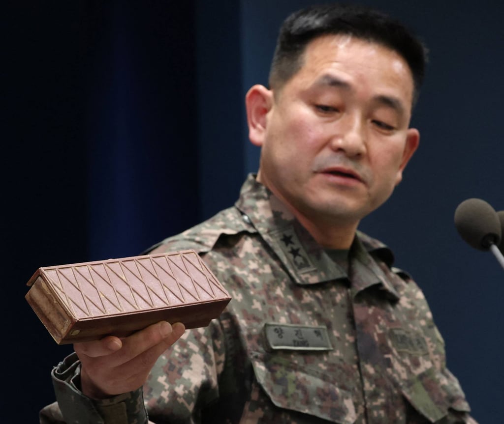 Yang Jin-hyeok, director of operations at South Korea’s Joint Chiefs of Staff, holds up a recovered North Korean landmine during a briefing in Seoul on October 5. Photo: Yonhap / AFP Yang Jin-hyeok, director of operations at South Korea’s Joint Chiefs of Staff, holds up a recovered North Korean landmine during a briefing in Seoul on October 5. Photo: Yonhap / AFP