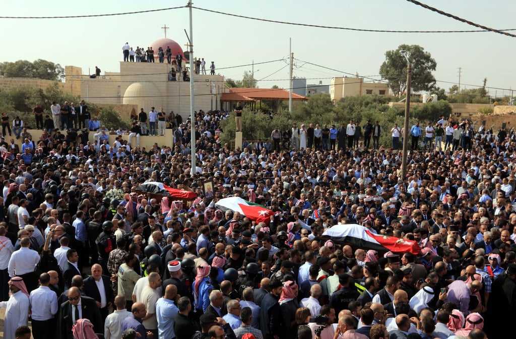 People attend a funeral of victims of a church shooting in Karak on Sunday. Photo: Xinhua People attend a funeral of victims of a church shooting in Karak on Sunday. Photo: Xinhua