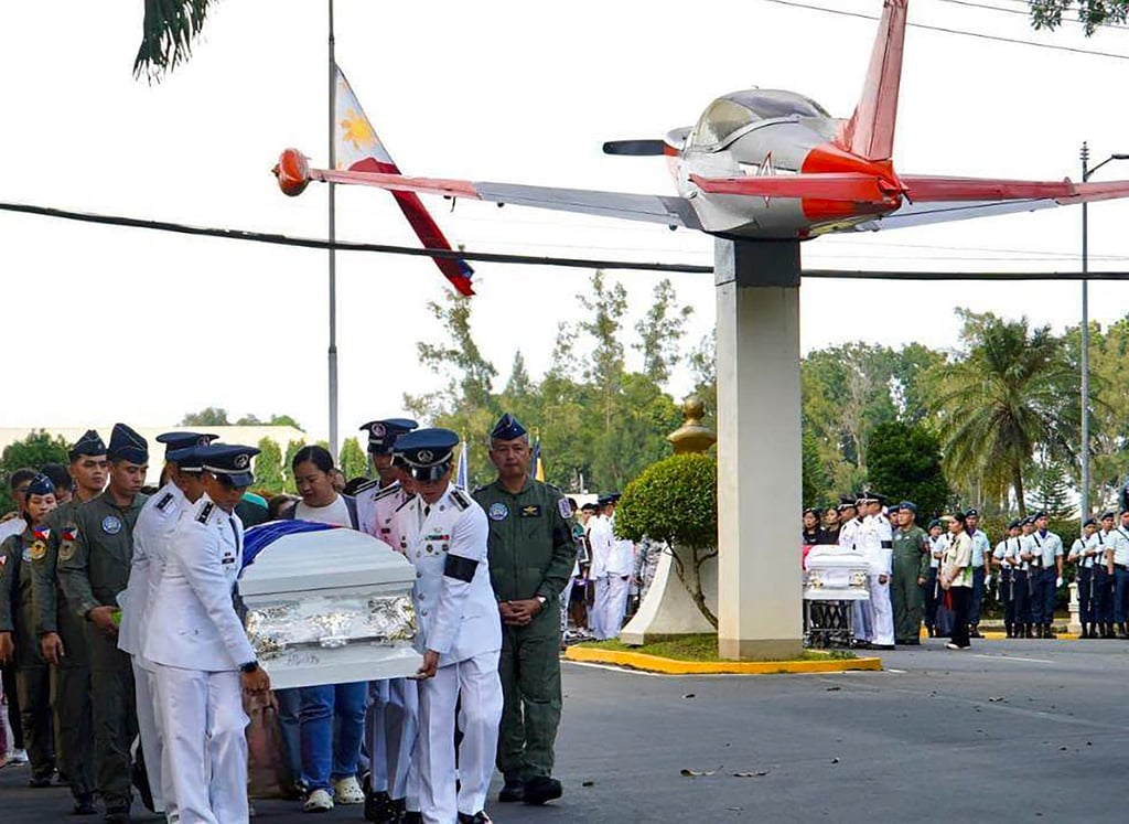 Philippine Air Force personnel carry a casket towards the base chapel at Fernando Air Base on Saturday, a day after the collision of two air force training aircraft killed four pilots. Photo: Facebook/PAF