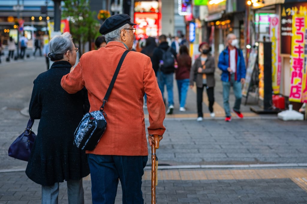 An elderly Japanese couple walking down a city street. Photo: Shutterstock An elderly Japanese couple walking down a city street. Photo: Shutterstock