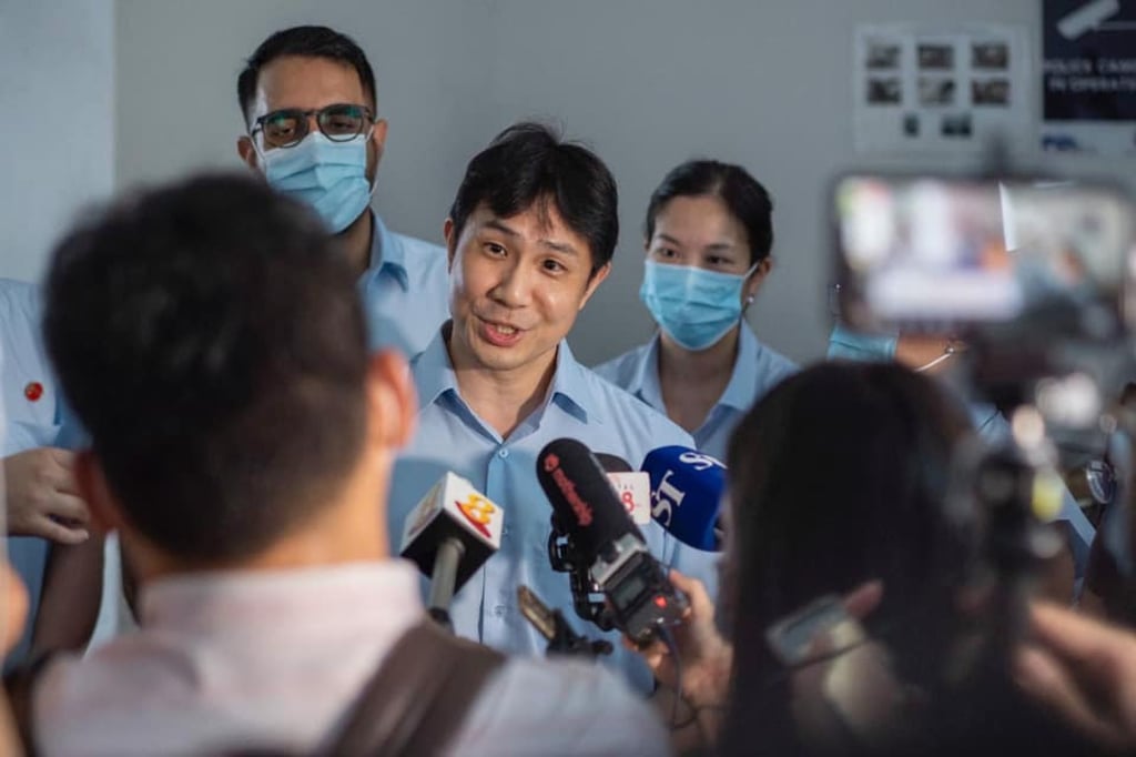 Jamus Lim (centre) of the Workers’ Party speaks to local media in 2020. Photo: Facebook
