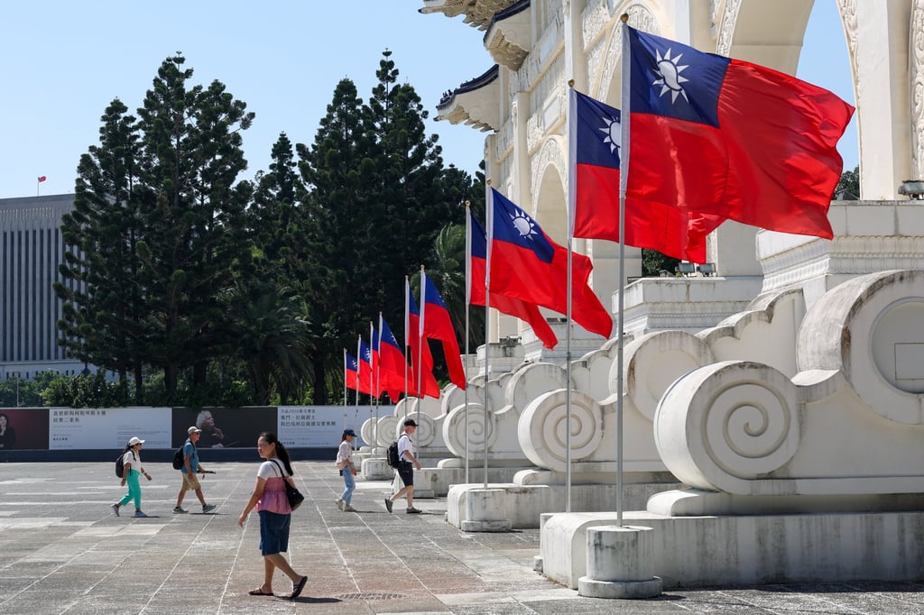 People walk past Taiwan flags outside Chiang Kai-shek Memorial Hall in Taipei on October 12. Photo: EPA People walk past Taiwan flags outside Chiang Kai-shek Memorial Hall in Taipei on October 12. Photo: EPA