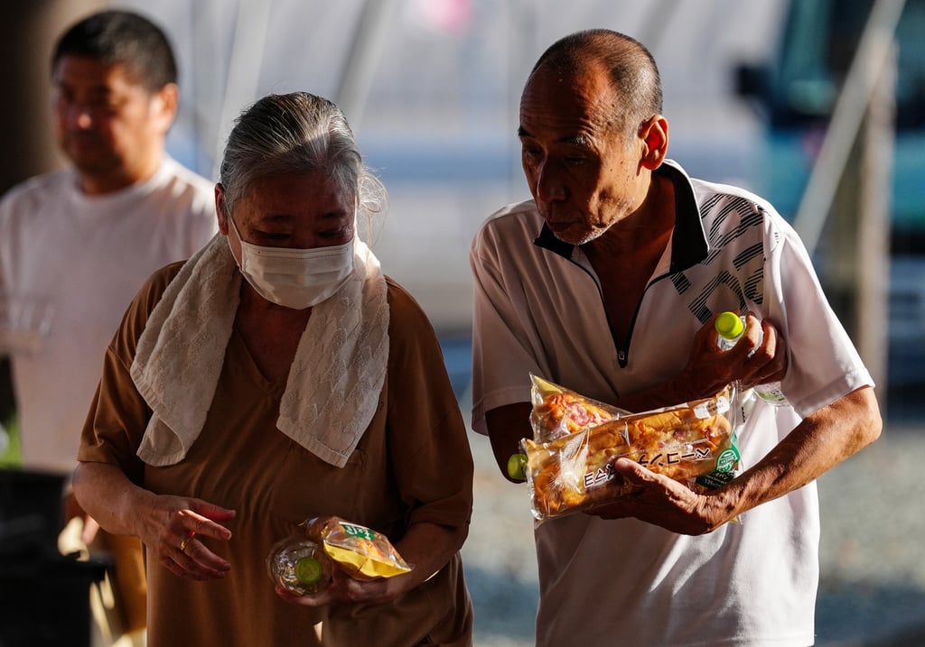 People receive relief materials at a shelter in Kumamoto prefecture on July 30. Photo: Xinhua