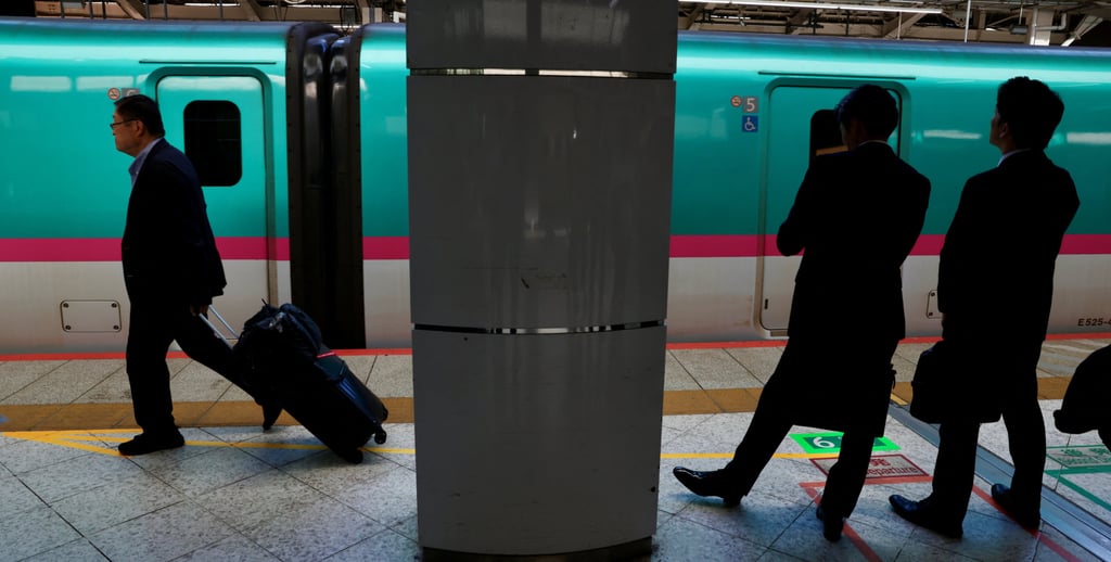 Commuters wait on a platform next to a JR East train at Tokyo Station in on October 8. Photo: Reuters Commuters wait on a platform next to a JR East train at Tokyo Station in on October 8. Photo: Reuters
