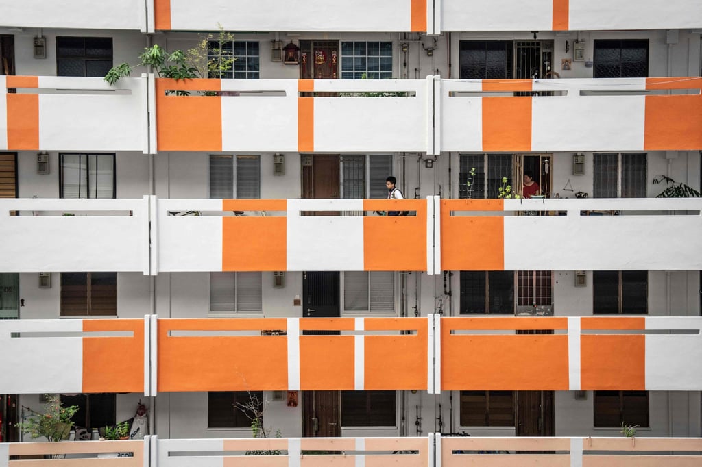 A student walks along the corridor of a public housing block in Singapore on October 19. Photo: AFP A student walks along the corridor of a public housing block in Singapore on October 19. Photo: AFP