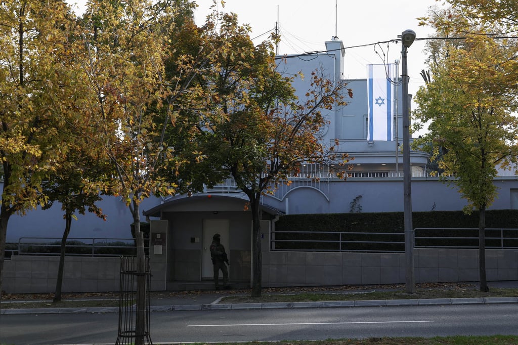 A Serbian gendarme stands guard after an attack in front of Israel’s embassy in Belgrade on Wednesday. Photo: Reuters
