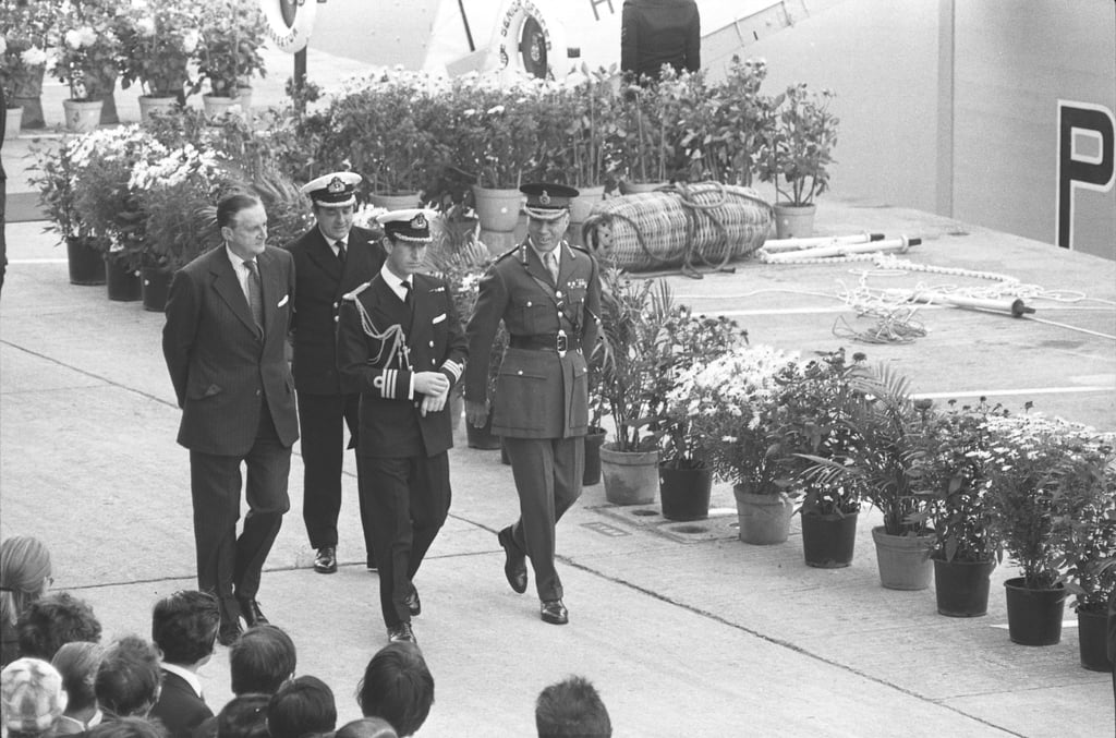 Prince Charles (front centre) is accompanied by Governor Sir Murray MacLehose (front left) and Commander British Forces Major-General Sir Roy Redgrave on his arrival at HMS Tamar. The then-prince was in Hong Kong for a three-day visit in 1979. Photo: SCMP Prince Charles (front centre) is accompanied by Governor Sir Murray MacLehose (front left) and Commander British Forces Major-General Sir Roy Redgrave on his arrival at HMS Tamar. The then-prince was in Hong Kong for a three-day visit in 1979. Photo: SCMP