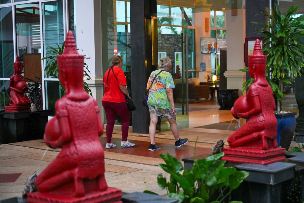 Villa Vie Residences Odyssey cruise ship passengers walk into a hotel in Sihanoukville, Cambodia, on Wednesday. Photo: AFP Villa Vie Residences Odyssey cruise ship passengers walk into a hotel in Sihanoukville, Cambodia, on Wednesday. Photo: AFP