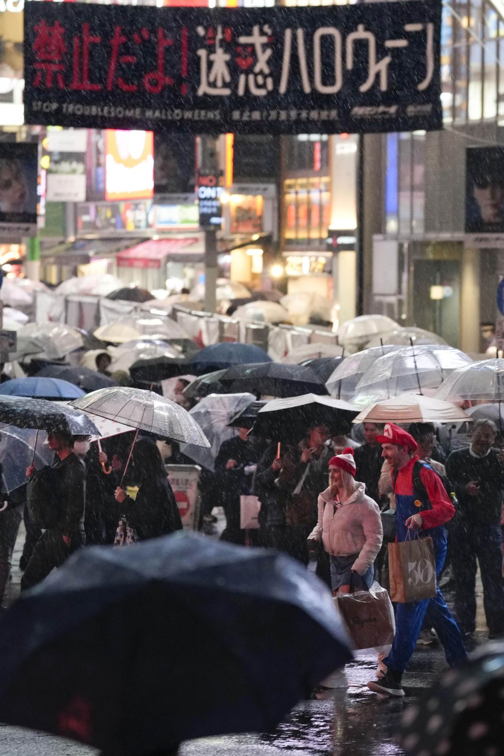 Crowds walk in the rain in Tokyo’s Shibuya district during last year’s Halloween festivities. Photo: Kyodo Crowds walk in the rain in Tokyo’s Shibuya district during last year’s Halloween festivities. Photo: Kyodo