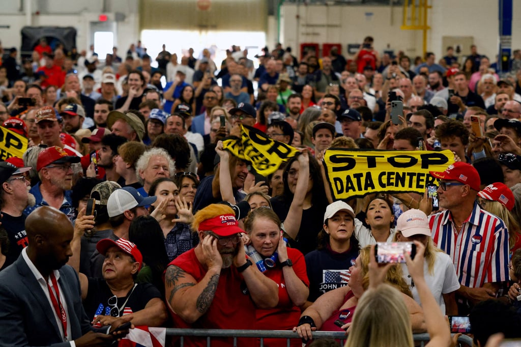 Protesters hold up signs against data centres in Milford, Michigan, in July. Photo: Reuters Protesters hold up signs against data centres in Milford, Michigan, in July. Photo: Reuters