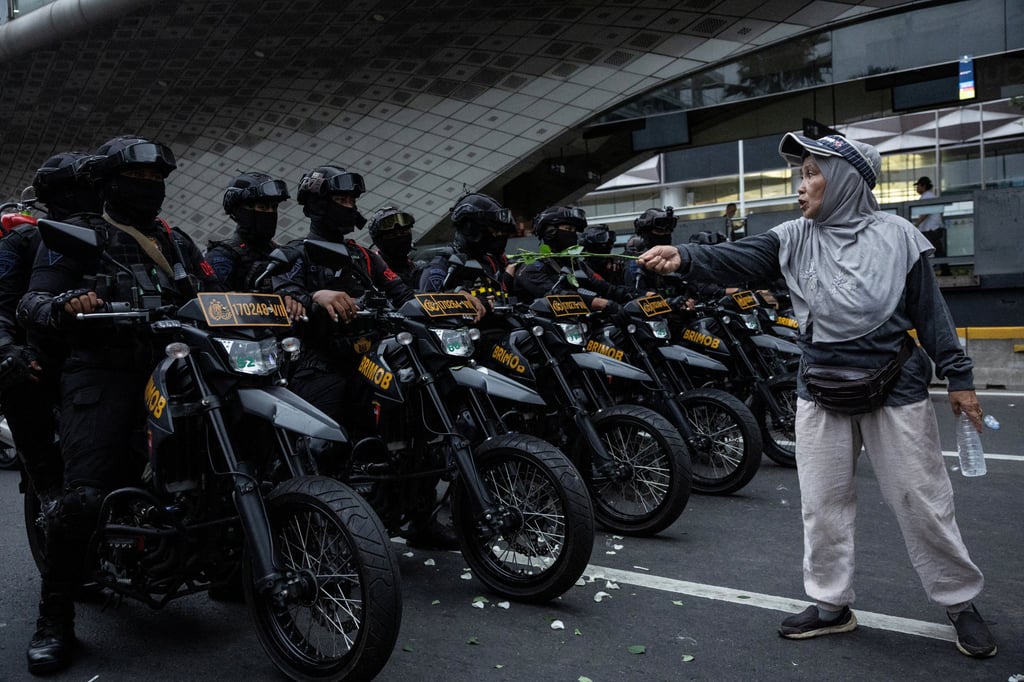 A woman confronts riot police during a protest against Indonesian President Prabowo Subianto’s policies, as well as his government’s handling of forest fires, in Jakarta, on Wednesday. Photo: Reuters