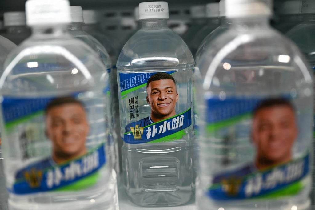 Bottles of an Eastroc Beverage energy drink featuring French footballer Kylian Mbappe are displayed at a convenience store in Beijing on October 27. The company cut ties with Mbappe the same day. Photo: AFP Bottles of an Eastroc Beverage energy drink featuring French footballer Kylian Mbappe are displayed at a convenience store in Beijing on October 27. The company cut ties with Mbappe the same day. Photo: AFP