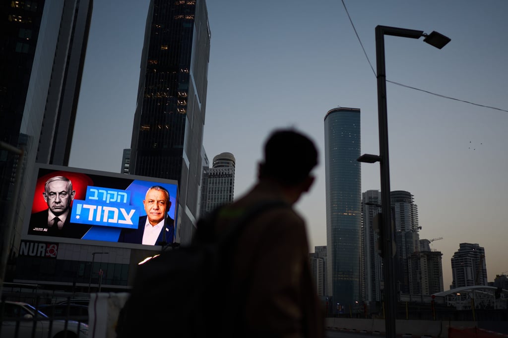 A pedestrian passes a campaign poster featuring Israeli Prime Minister Benjamin Netanyahu (left) and his main rival, opposition candidate Gadi Eisenkot, in Tel Aviv on October 23. Photo: AP A pedestrian passes a campaign poster featuring Israeli Prime Minister Benjamin Netanyahu (left) and his main rival, opposition candidate Gadi Eisenkot, in Tel Aviv on October 23. Photo: AP