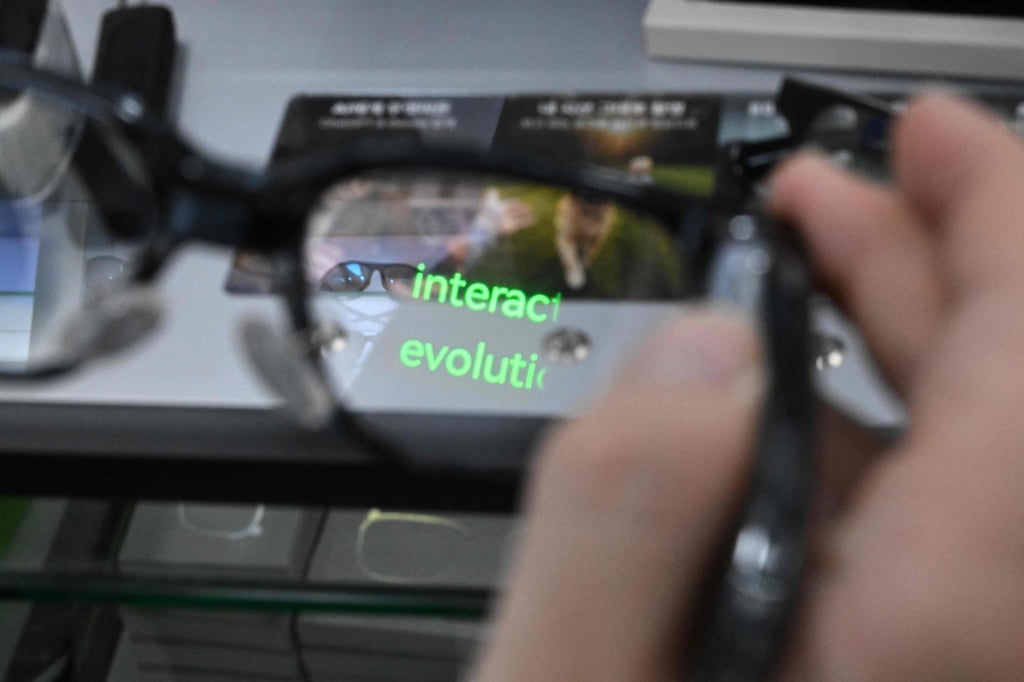 An optometrist holds a pair of smart glasses at an eyewear store in Seoul on Friday. Photo: AFP