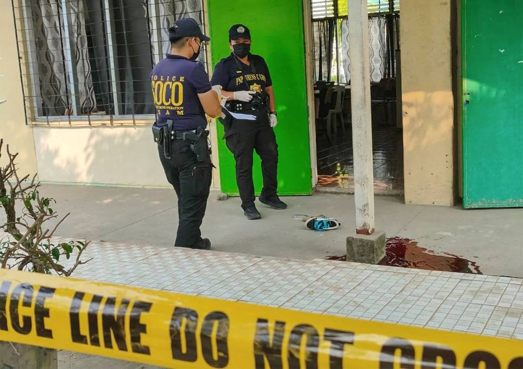Police investigators inspect the scene outside a classroom at Banga National High School in South Cotabato, southern Philippines in September, following a shooting that left several dead. Photo: AFP
