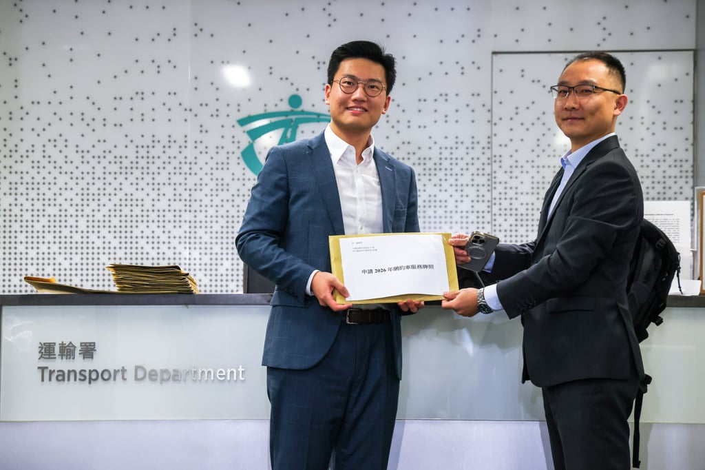 Arnold Yeung, left, head of public affairs for Amap Hong Kong, poses with licence application documents. Photo: Silvia Siu
