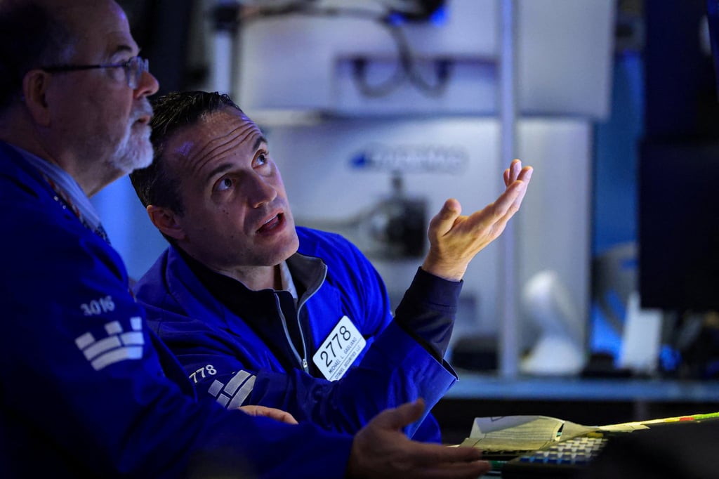 Traders work on the floor at the New York Stock Exchange on Friday. Photo: Reuters