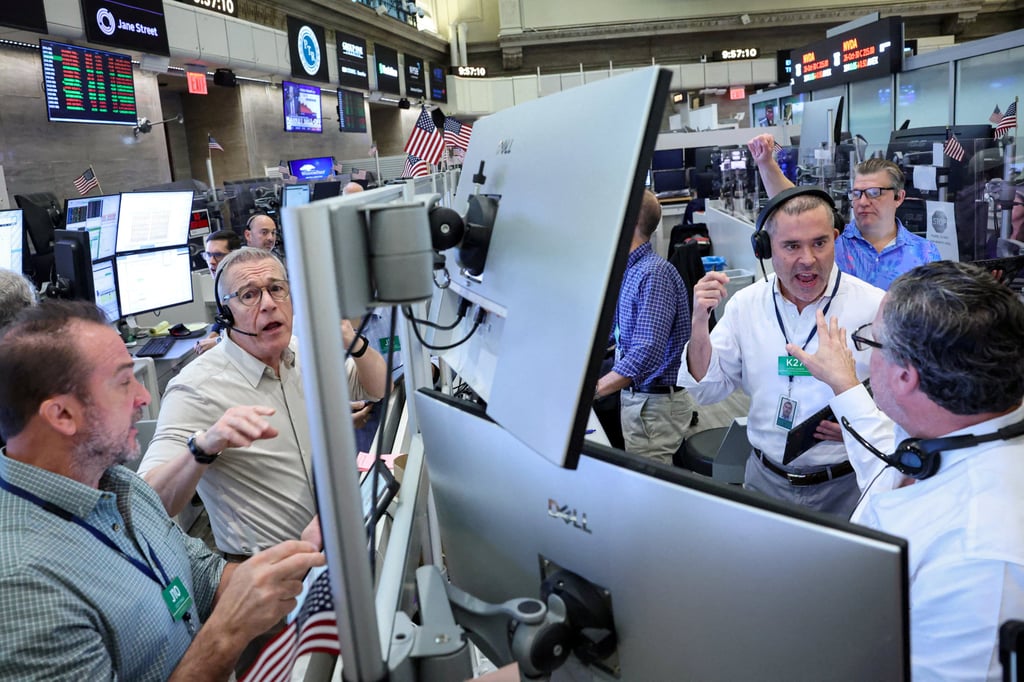 Traders work on the floor at the New York Stock Exchange on Friday. Photo: Reuters