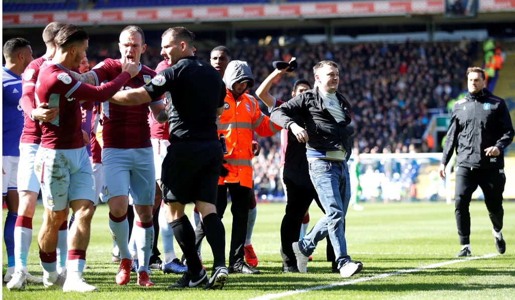 Paul Mitchell ran on to the pitch and hit Jack Grealish from behind about 10 minutes into Sunday’s game. Photo: Reuters