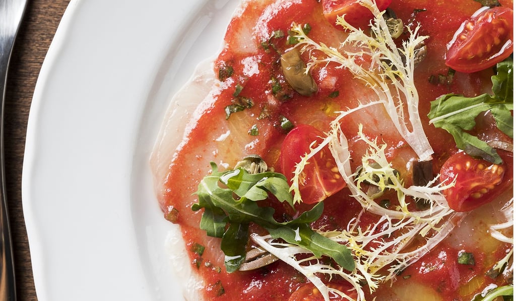 Crudo of hamachi with cherry tomatoes, olives and basil, served carpaccio style. Crudo of hamachi with cherry tomatoes, olives and basil, served carpaccio style.