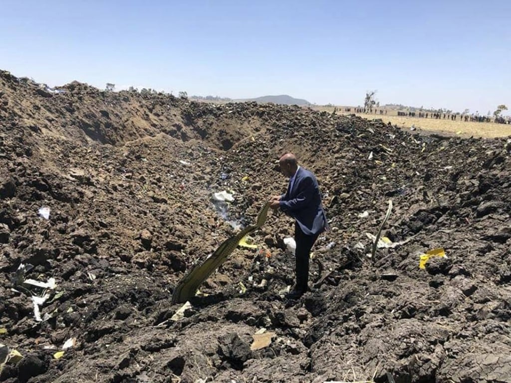 In this photo taken from the Ethiopian Airlines Facebook page, the CEO of Ethiopian Airlines, Tewolde Gebremariam, looks at the wreckage of the plane that crashed soon after take-off from Addis Ababa, Ethiopia, Sunday March 10, 2019. Photo: Facebook via AP