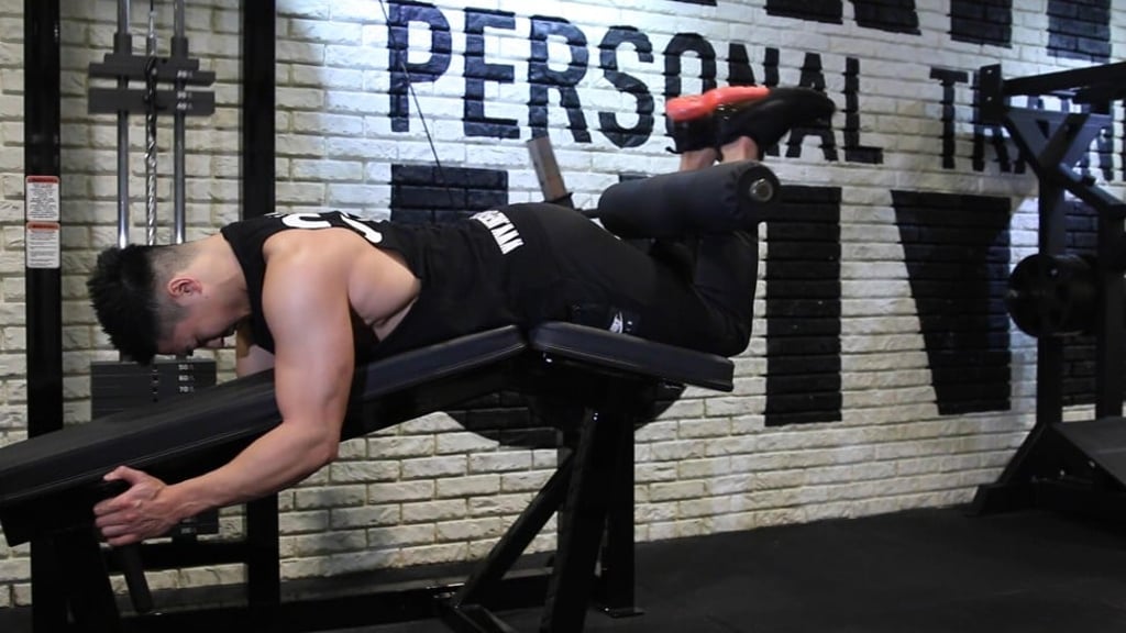 Jon Lee, instructor and co-founder of ONE Personal Training, in Central, who acts as your video guide, shows how to carry out lying leg curls.