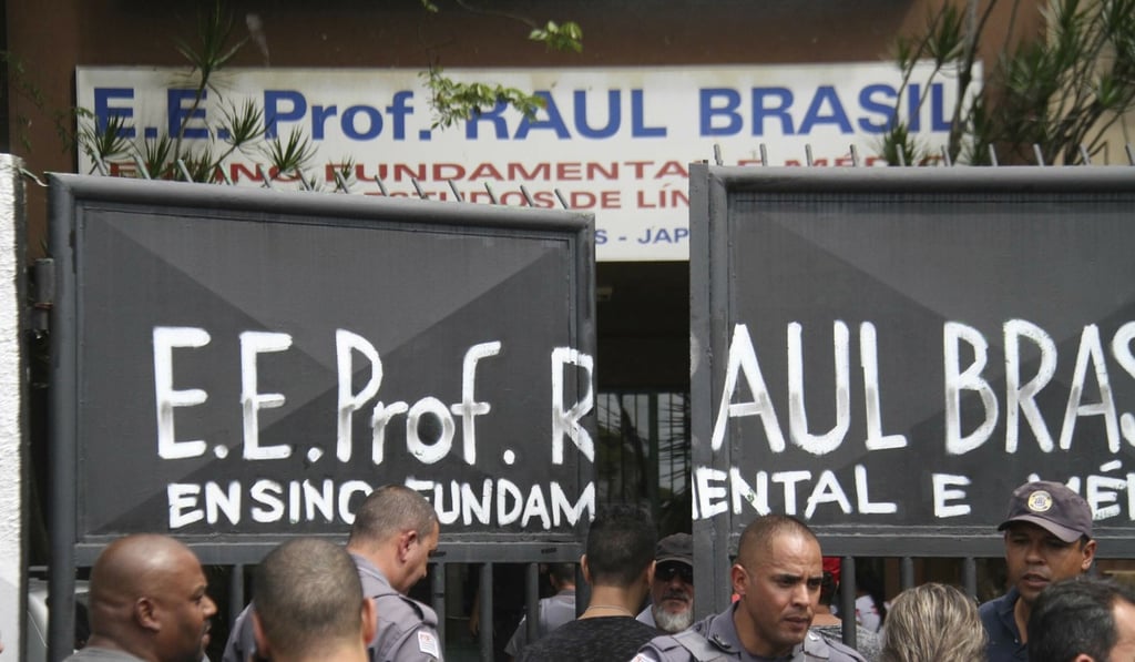 Police officers guard the entrance of the Raul Brasil State School in Suzano, Brazil. Photo: Futura Press via AP Police officers guard the entrance of the Raul Brasil State School in Suzano, Brazil. Photo: Futura Press via AP
