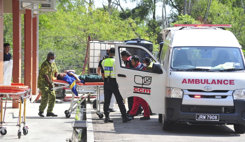 Emergency personnel attend to a student in Pasir Gudang, Johor state. Photo: AP