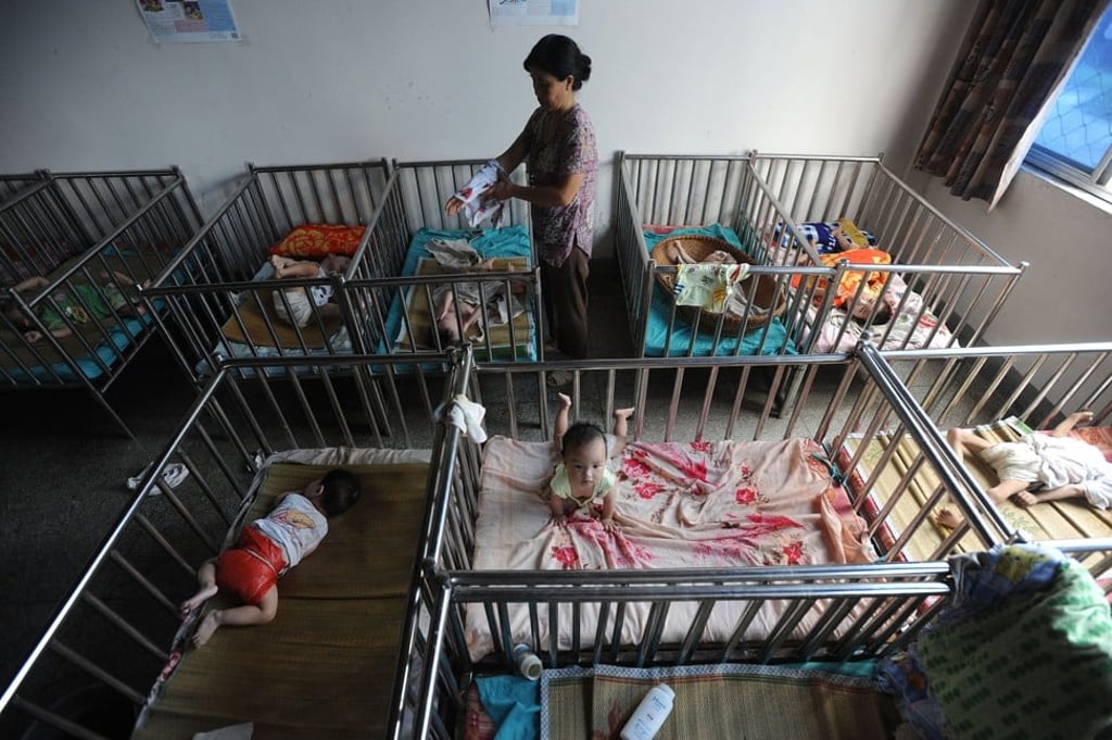 A Chinese worker cares for the babies at an orphanage in Wuhu, in eastern China's Anhui province on this 2009 file photo. Photo: AFP