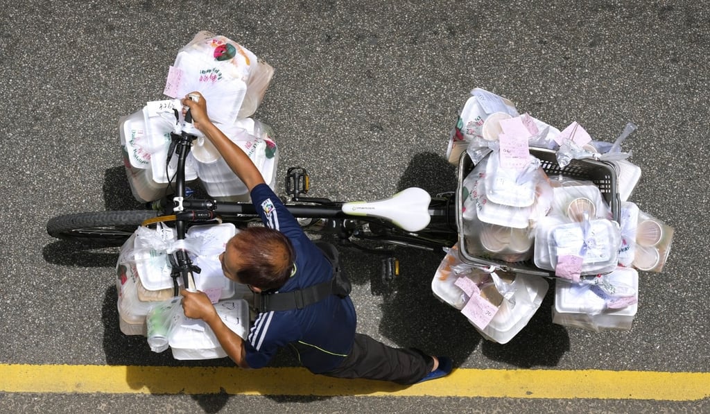 Chang Kim-fung, an assistant photo editor, took first runner-up in feature photography for this image of a delivery rider overloaded with takeout lunches in Wan Chai. Photo: Chang Kim-fung