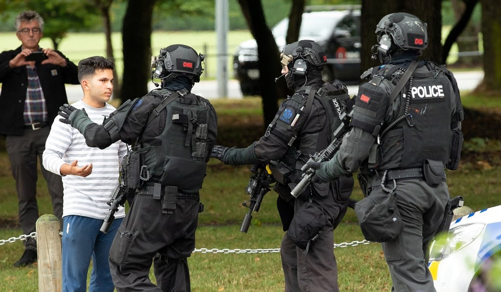 Officers from the Armed Offenders Squad push back members of the public following the shooting. Photo: Reuters