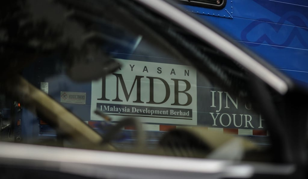 The 1MDB logo is seen through the window of a car in Kuala Lumpur. Photo: AFP
