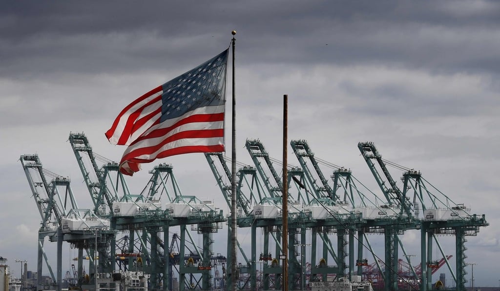 The US flag flies over shipping cranes and containers after a report said the United States and China are close to reaching a major trade deal that would see both sides lower some of the tariffs imposed during an often-bitter trade war. Photo: AFP The US flag flies over shipping cranes and containers after a report said the United States and China are close to reaching a major trade deal that would see both sides lower some of the tariffs imposed during an often-bitter trade war. Photo: AFP