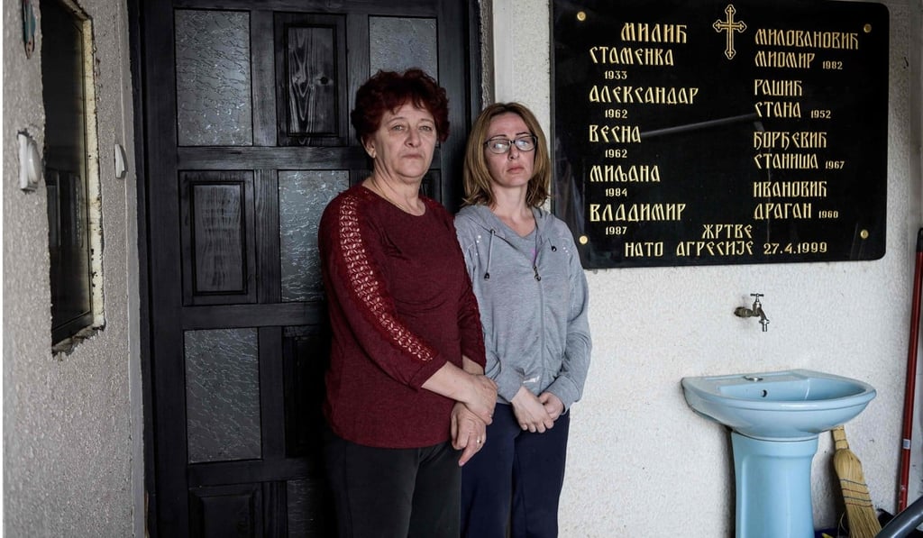 Ivana Mitic (right) and her mother Milica Milovanovic in front of a memorial plate at their home in Surdulica on March 6, 2019. Photo: AFP Ivana Mitic (right) and her mother Milica Milovanovic in front of a memorial plate at their home in Surdulica on March 6, 2019. Photo: AFP
